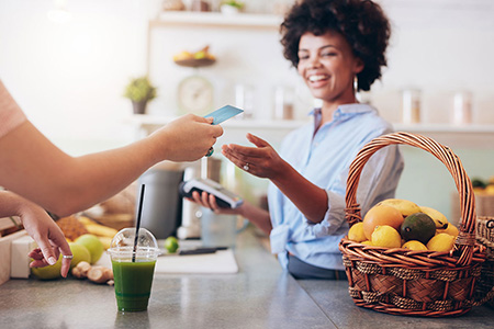 Lady at Juice Bar making a payment
